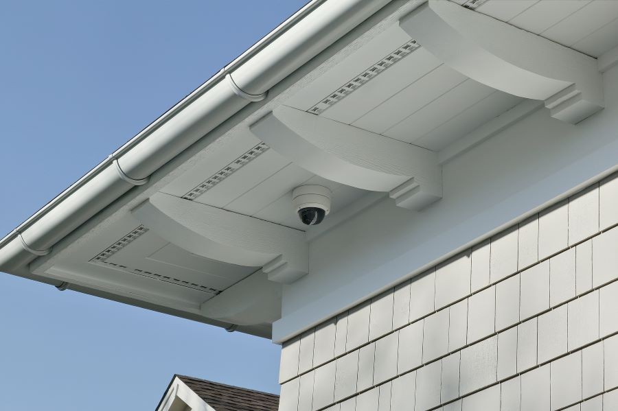 An exterior HDR security camera placed under a home’s eave.
