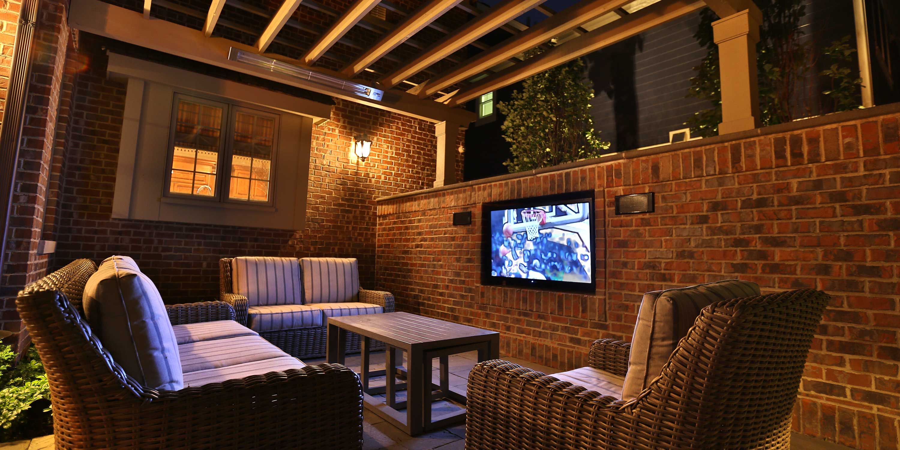 brick patio with entertainment and warm lighting