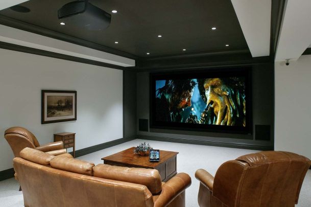 Home theater with LED lighting and leather furniture