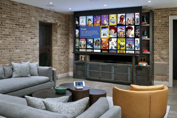 Media room with large projector screen and brick walls