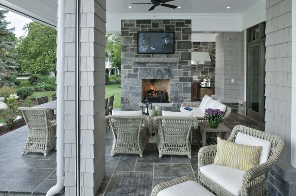 patio with tv on brick wall above fireplace